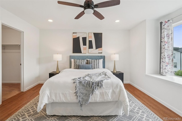 8926 Swan River St, Littleton, CO 80125 - bedroom featuring wood finished floors, a spacious closet, ceiling fan, recessed lighting, and a closet
