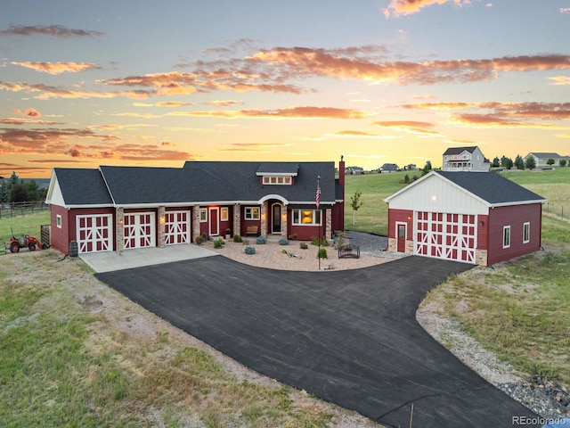 3124 Antelope Ridge Trl, Parker, CO 80138 - view of front of home featuring an outdoor structure, roof with shingles, a lawn, covered porch, and asphalt driveway