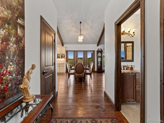 3124 Antelope Ridge Trl, Parker, CO 80138 - hallway with dark wood-style flooring, vaulted ceiling, and a chandelier