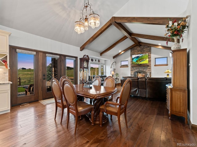 3124 Antelope Ridge Trl, Parker, CO 80138 - dining space featuring wood-type flooring, a chandelier, a stone fireplace, and french doors