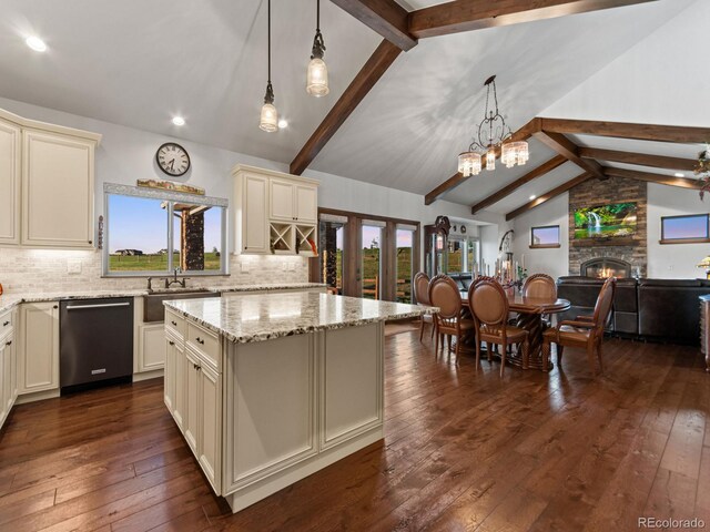 3124 Antelope Ridge Trl, Parker, CO 80138 - kitchen with stainless steel dishwasher, cream cabinetry, decorative backsplash, dark wood-type flooring, and recessed lighting