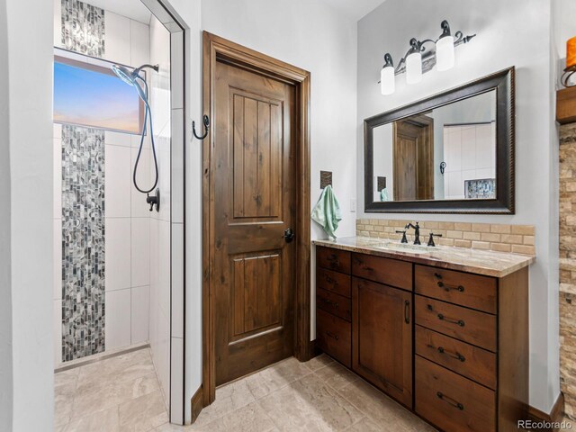 3124 Antelope Ridge Trl, Parker, CO 80138 - full bathroom with a tile shower, vanity, and tasteful backsplash