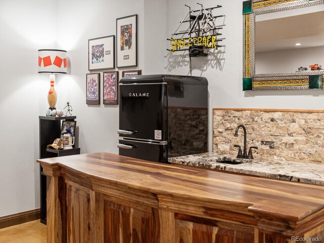 3124 Antelope Ridge Trl, Parker, CO 80138 - indoor wet bar featuring fridge and tasteful backsplash