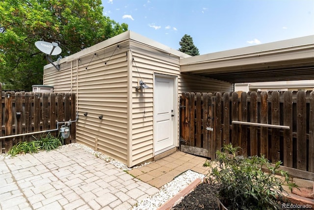 view of outbuilding with fence and an outbuilding