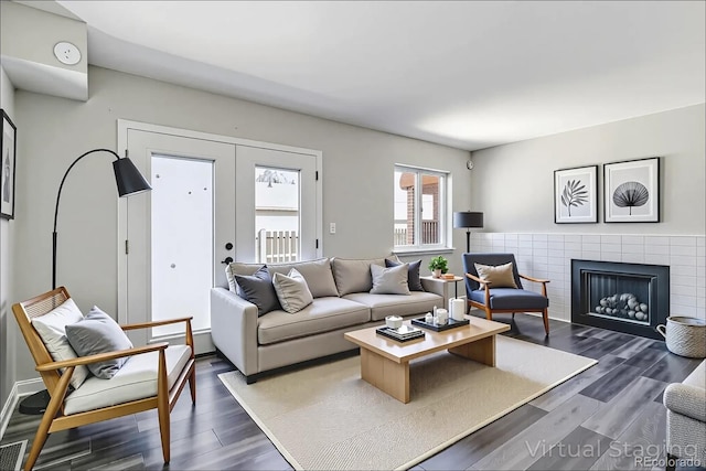 1202 S Troy St, Aurora, CO 80012 - living area with dark wood-type flooring, a brick fireplace, and french doors