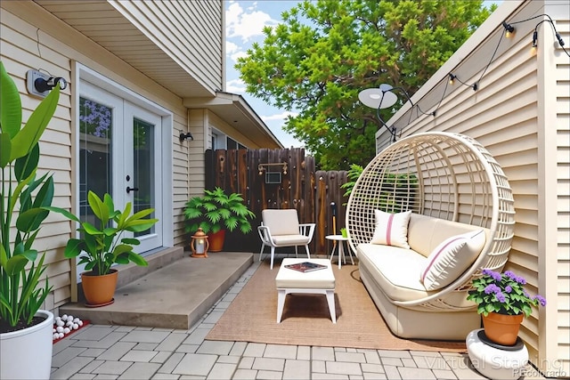1202 S Troy St, Aurora, CO 80012 - view of patio / terrace featuring an outdoor living space with a fire pit and french doors