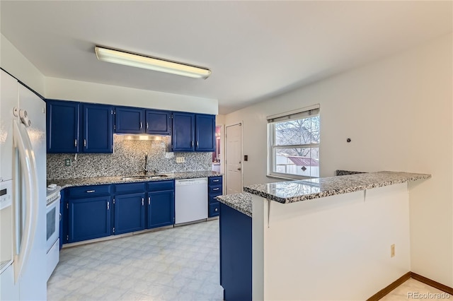 kitchen featuring white appliances, blue cabinetry, and kitchen peninsula