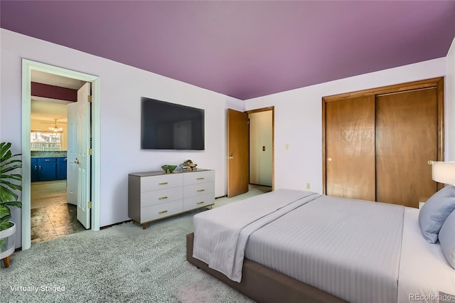 bedroom featuring a closet and light carpet