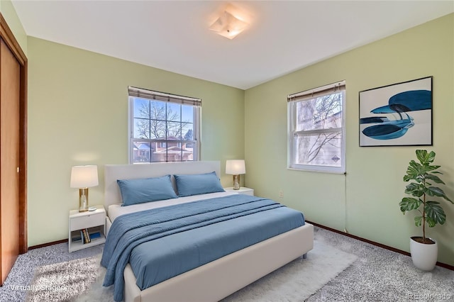 bedroom with light colored carpet and a closet