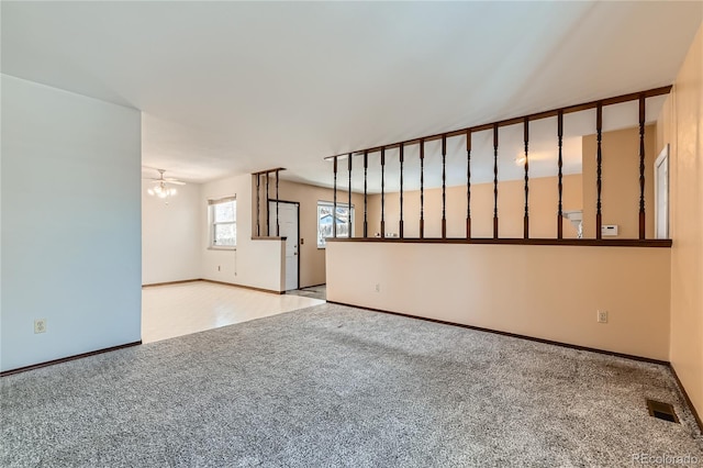 unfurnished living room featuring light carpet