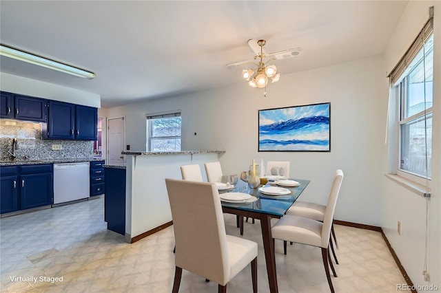 dining area with sink and a chandelier