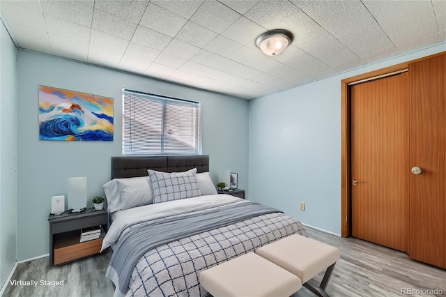 bedroom with wood-type flooring