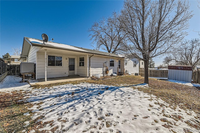 snow covered property featuring a storage unit