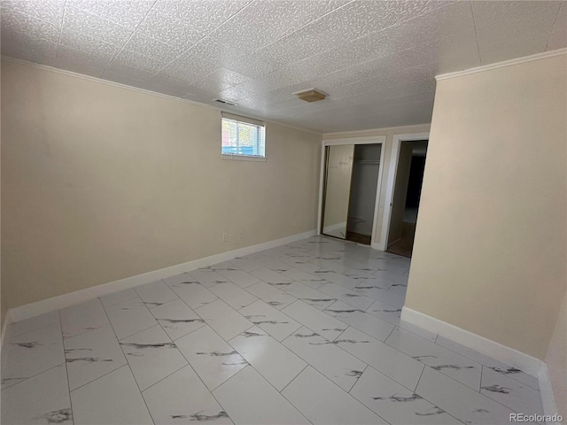 11623 E Virginia Dr, Aurora, CO 80012 - spare room featuring marble finish floor, crown molding, and baseboards