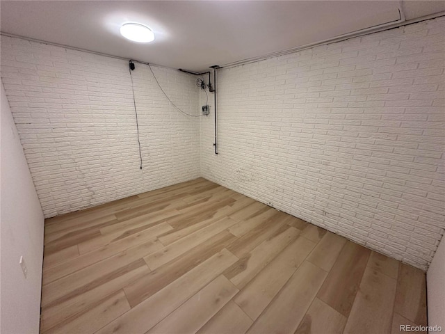 11623 E Virginia Dr, Aurora, CO 80012 - finished below grade area with brick wall and light wood-style floors