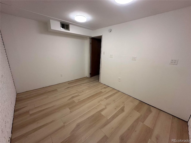 11623 E Virginia Dr, Aurora, CO 80012 - spare room featuring light wood-style flooring and visible vents