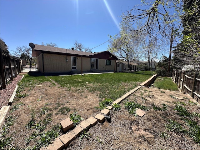 11623 E Virginia Dr, Aurora, CO 80012 - view of yard with a fenced backyard and a patio