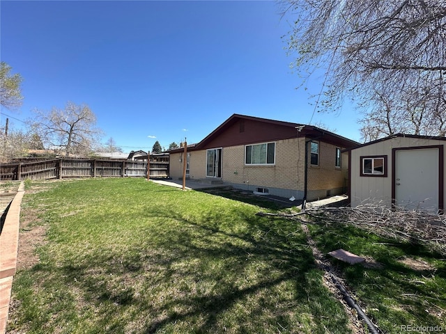 11623 E Virginia Dr, Aurora, CO 80012 - view of yard with a fenced backyard, an outbuilding, a patio, and a storage unit