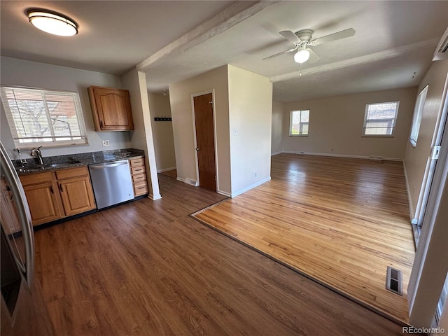 11623 E Virginia Dr, Aurora, CO 80012 - kitchen featuring stainless steel dishwasher, wood finished floors, a sink, open floor plan, and visible vents