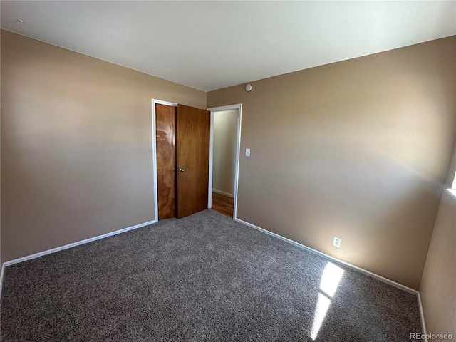 11623 E Virginia Dr, Aurora, CO 80012 - spare room with baseboards and carpet flooring