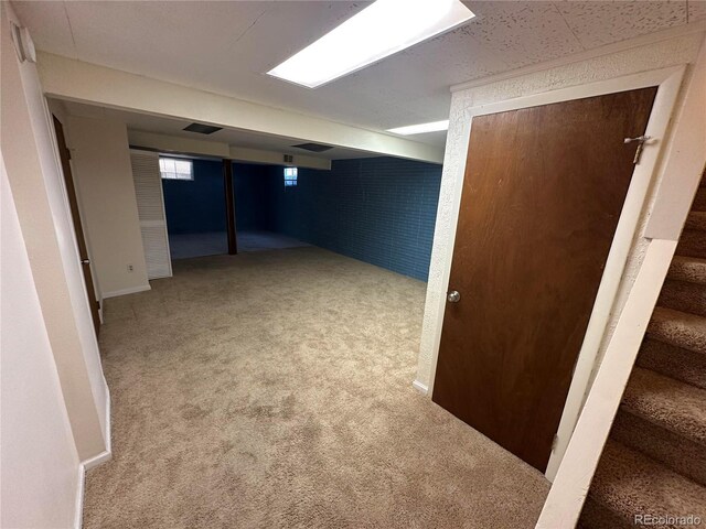 11623 E Virginia Dr, Aurora, CO 80012 - basement with visible vents, carpet floors, and stairs