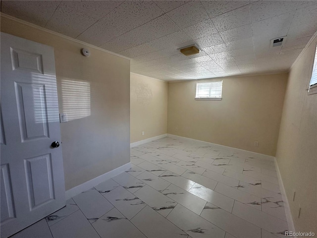 11623 E Virginia Dr, Aurora, CO 80012 - basement featuring marble finish floor, baseboards, crown molding, and visible vents