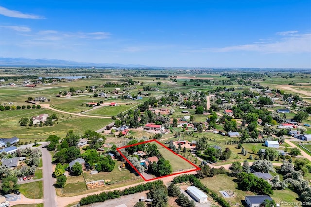 1813 Pikes Peak St, Erie, CO 80516 - aerial view of property and surrounding area with property boundaries highlighted and a mountain backdrop