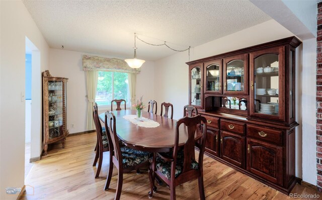 1813 Pikes Peak St, Erie, CO 80516 - dining area featuring light wood-type flooring and a textured ceiling