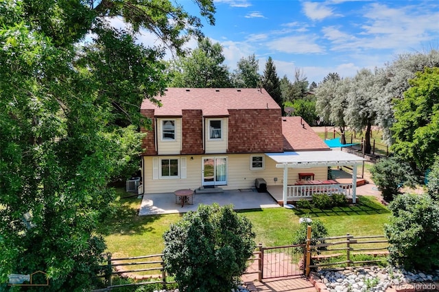 1813 Pikes Peak St, Erie, CO 80516 - rear view of property featuring a patio area and a shingled roof