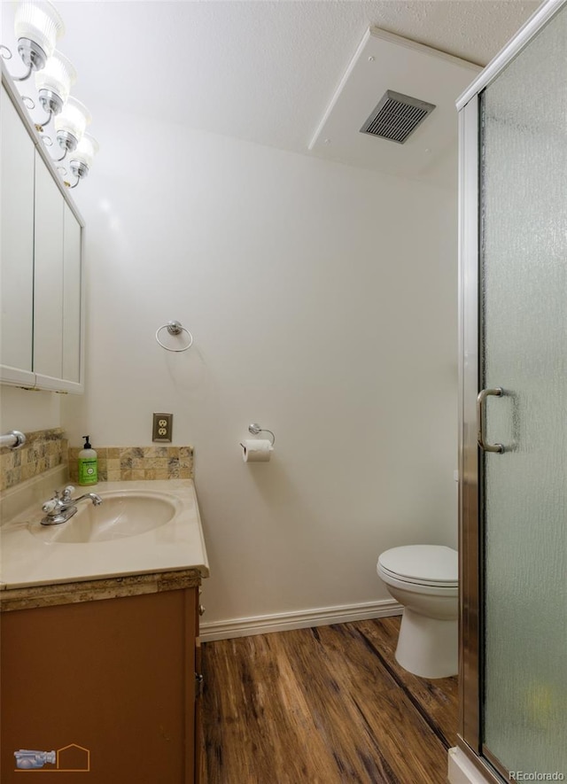 1813 Pikes Peak St, Erie, CO 80516 - bathroom featuring vanity, wood finished floors, and a shower stall