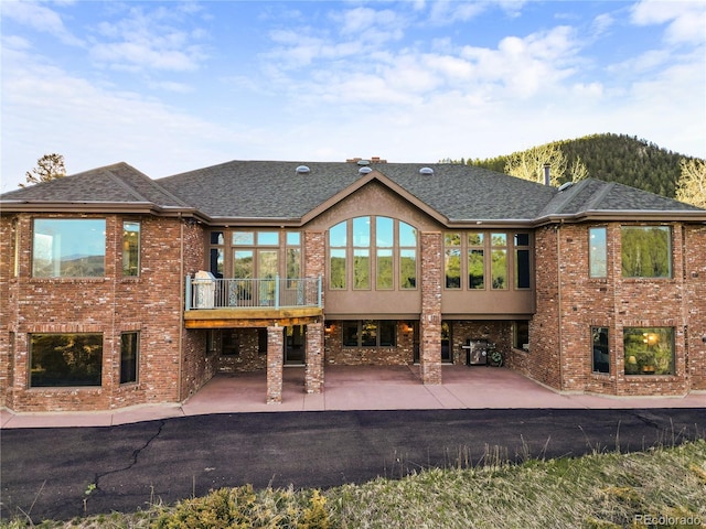 rear view of property featuring a patio area