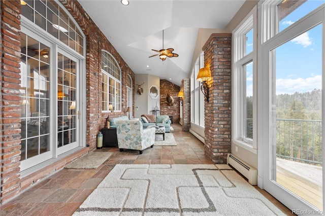 unfurnished sunroom featuring ceiling fan, a baseboard heating unit, and vaulted ceiling