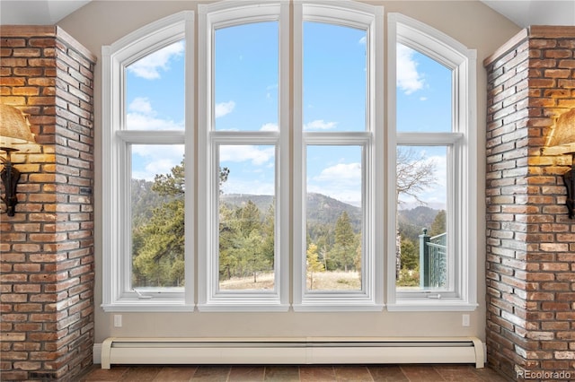 doorway to outside with a baseboard heating unit and a mountain view