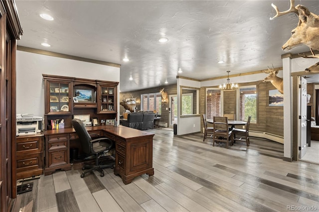 office area with a chandelier and light hardwood / wood-style floors