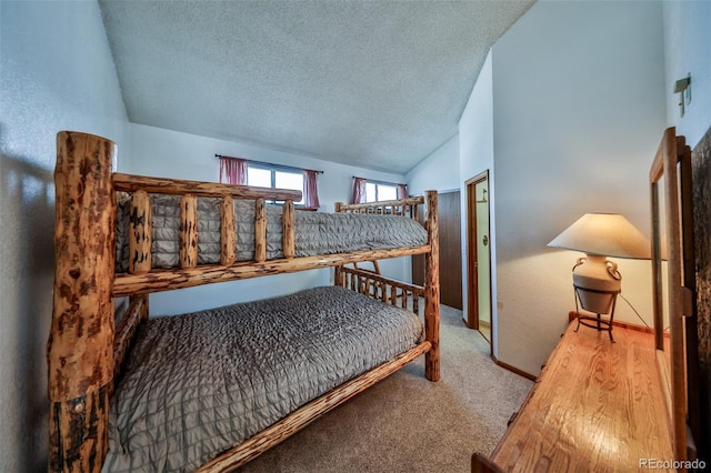 56 Gcr 834 Unit 2F, Fraser, CO 80442 - bedroom featuring lofted ceiling, carpet flooring, and a textured ceiling