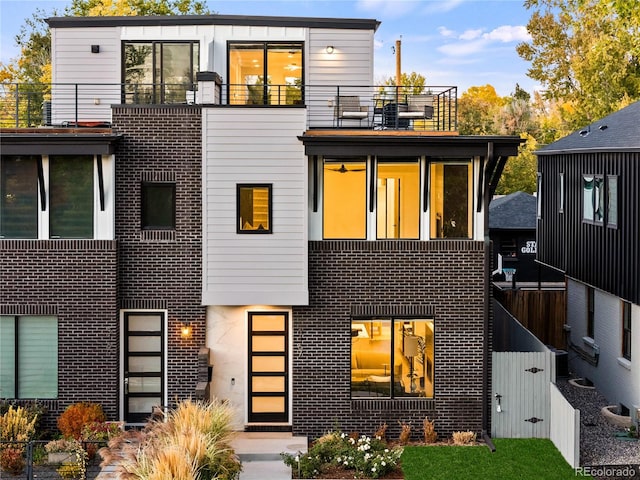 view of front facade with a balcony and central AC unit