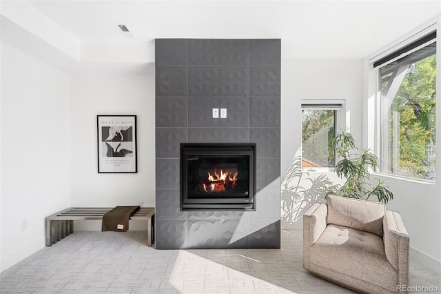 sitting room with a tiled fireplace