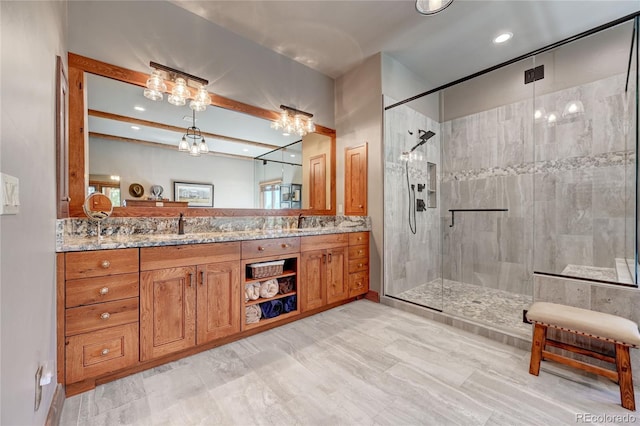 bathroom featuring beamed ceiling, vanity, and a shower with shower door