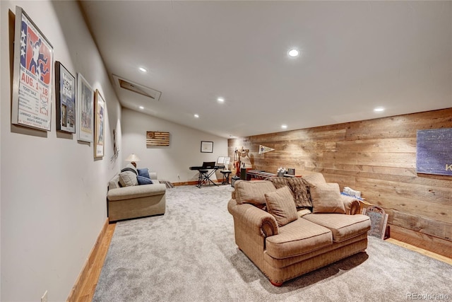 living room featuring vaulted ceiling and wooden walls