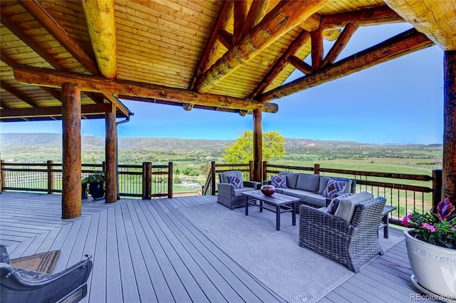 deck featuring a rural view, a mountain view, a gazebo, and an outdoor hangout area