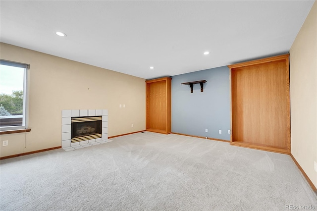 13008 Grove Way, Broomfield, CO 80020 - unfurnished living room featuring baseboards, a tile fireplace, recessed lighting, and light colored carpet