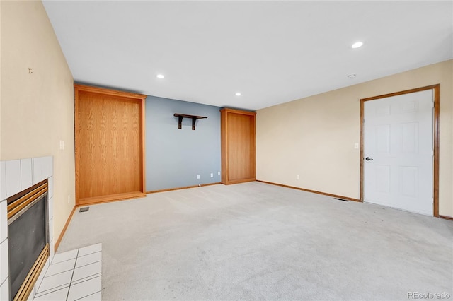 13008 Grove Way, Broomfield, CO 80020 - unfurnished living room featuring a tiled fireplace, recessed lighting, baseboards, and light carpet