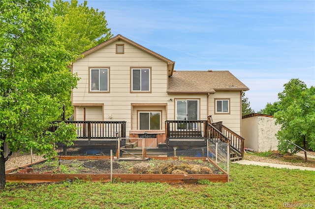 13008 Grove Way, Broomfield, CO 80020 - rear view of property with a vegetable garden, a yard, a shingled roof, and a deck
