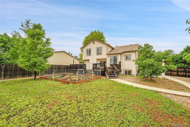 13008 Grove Way, Broomfield, CO 80020 - back of property featuring a vegetable garden and a deck