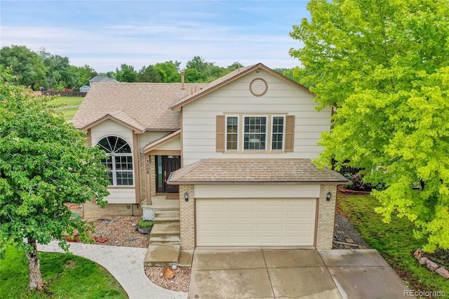 13008 Grove Way, Broomfield, CO 80020 - view of front of home featuring a garage, brick siding, concrete driveway, and roof with shingles