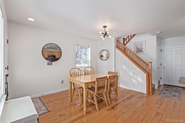 dining area featuring an inviting chandelier and light wood-type flooring