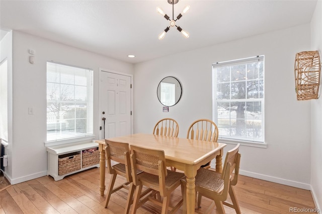 dining room with a wealth of natural light and light hardwood / wood-style floors