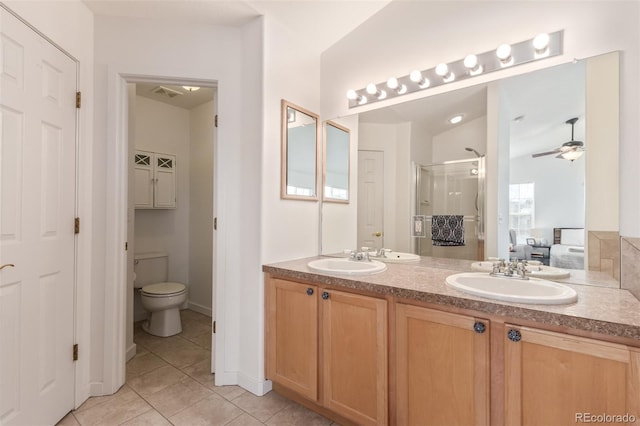 bathroom with vanity, an enclosed shower, ceiling fan, toilet, and tile patterned floors