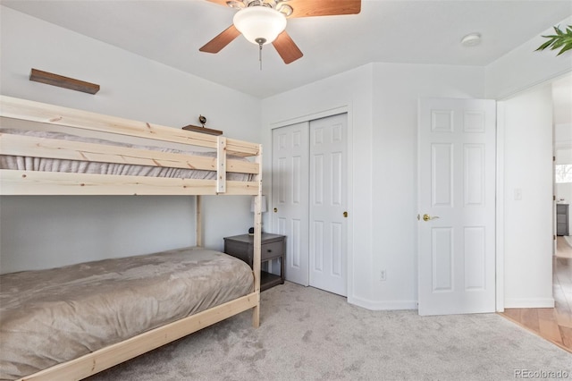 carpeted bedroom featuring a closet and ceiling fan