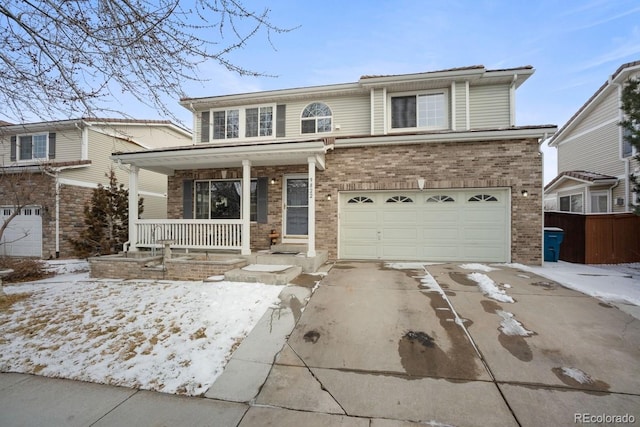 view of front property featuring covered porch and a garage